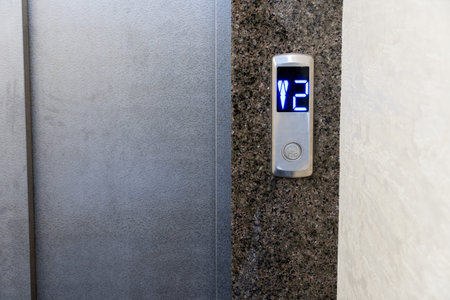 Modern elevator controls seamlessly integrated into a stylish apartment building with illuminated...