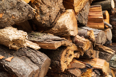 Chopped stacked firewood close up, soft focus.の写真素材