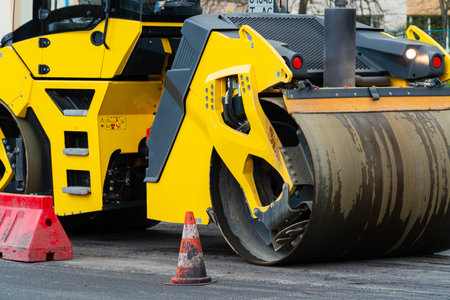 Close up on the road roller working on the new road construction site. Road construction.の写真素材