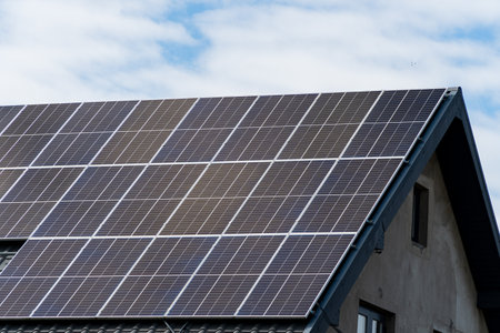 Solar panel on sheet black metal roof.の写真素材