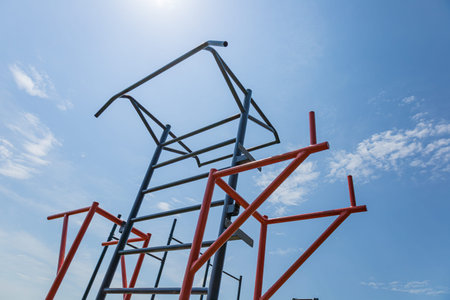 Parallel bars stand tall in an outdoor gym, promoting active lifestyles and strength training under...