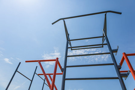 Sporting equipment designed for strength training stands tall against a clear blue sky, encouraging...