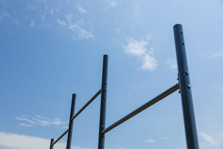 Parallel bars stand in a sunlit gym setting, inviting users to practice exercises for strength and...