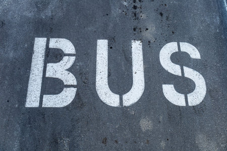Large letters spelling out bus mark a designated parking area, emphasizing public transport availability at the location.の写真素材