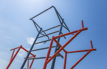 Participants are actively training on horizontal bars in a fitness park, enjoying the sunny weather and engaging in physical activity.の写真素材