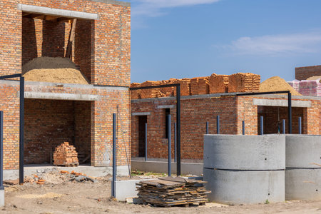 Construction workers are building new residential homes using bricks and concrete in a developing...