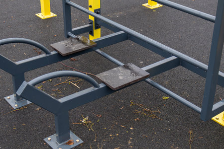 Wet fitness equipment stands ready for use in a public park on a cloudy day, inviting local...