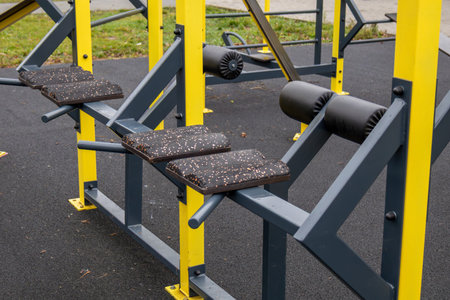 Colorful outdoor exercise equipment is set up in a city park, promoting fitness and healthy living...
