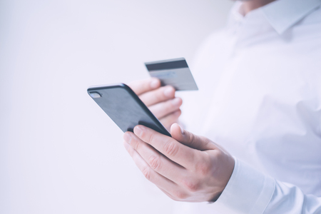 Man holding smartphone and credit cardの写真素材