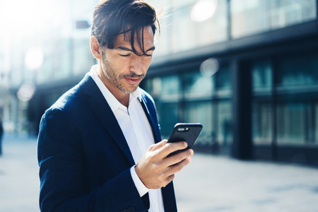 Man with smartphone outdoorの写真素材