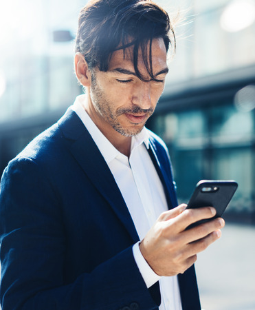 Man with smartphone outdoorの写真素材