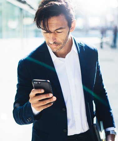 Man with smartphone outdoorの写真素材