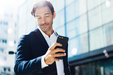 Man with smartphone outdoorの写真素材