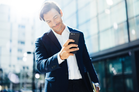 Man with smartphone outdoorの写真素材
