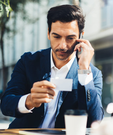 Man with laptop and smartphone working outdoorの写真素材