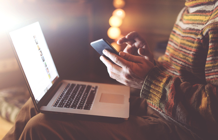 Man using smaptphone and laptopの写真素材