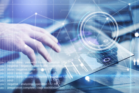 Man working on a project using futuristic digital tabletの写真素材