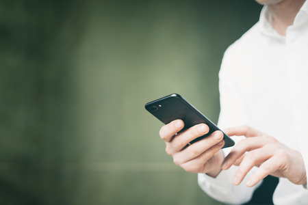 Male hands with smartphoneの写真素材