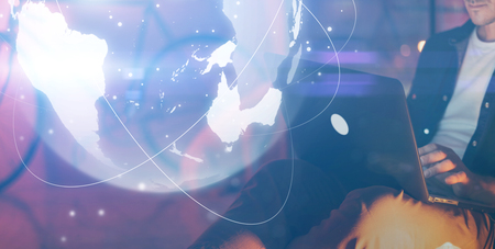 Man with laptop and abstract hologram of a globe. Interface and communication concept.の写真素材