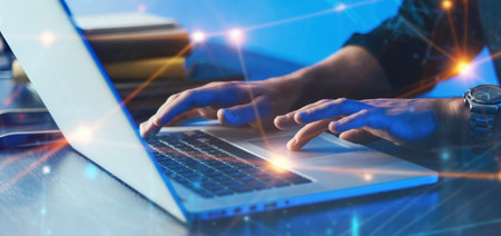 Close-up photo of male hands with laptop. Man is working remotely from home. Freelancer at workの写真素材
