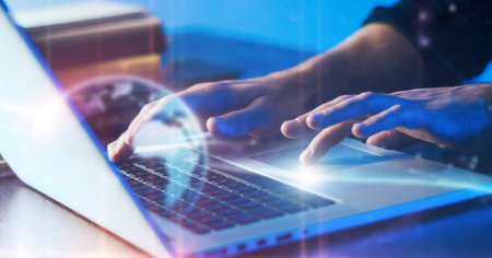 Close-up photo of male hands with laptop. Man is working remotely from home. Freelancer at workの写真素材