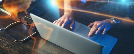 Close-up photo of male hands with laptop. Man is working remotely from home. Freelancer at workの写真素材
