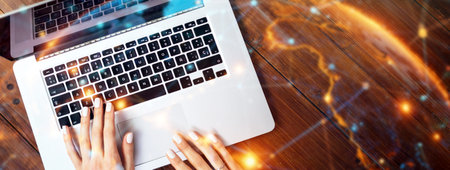 Young woman working on laptop. Freelancer at remote work. Female student learning on-line via...
