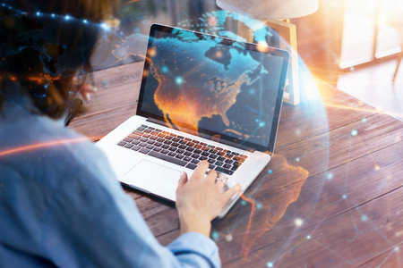 Young beautiful woman working with a laptop. Global network conceptの写真素材