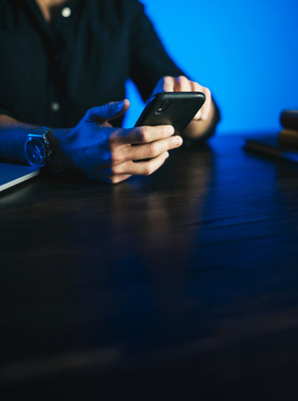Man pointing on smartphone screen, chatting in social networks, meeting website, searching internet, sending sms, using text messenger or online banking. Close up of male hands. Remote workの写真素材
