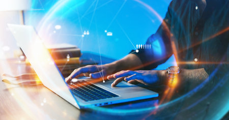 Close-up photo of male hands with laptop. Man is working remotely from home. Freelancer at workの写真素材