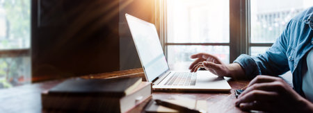 Close-up photo of male hands with laptop, freelancer at workの写真素材