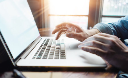 Close-up photo of male hands with laptop, freelancer at workの写真素材
