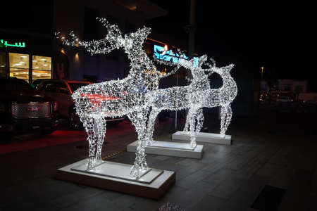 Glowing reindeer made of wire and light bulbs. Christmas decorations. Christmas Lights on reindeer shape wire frame mesh. Deer Christmas outdoor decoration. Decorative Lights- Dubai UAE December 2019のeditorial素材