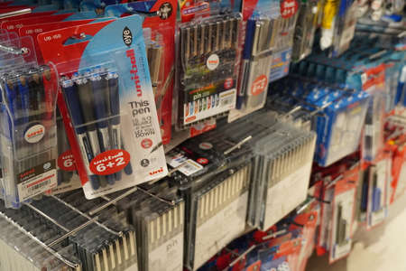 Pens in their packages hanging for sale in store. Pens in stationary store. Writing supplies. Colorful beautiful pen shelves in office supply store - Dubai UAE December 2019のeditorial素材