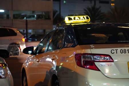 Dubai UAE - November 2019: Dubai public taxi is parked in a parking lot at night. Taxi in the city of Dubai - Dubai has an extensive taxi system RTA.のeditorial素材