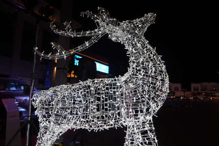 Glowing reindeer made of wire and light bulbs. Christmas decorations. Christmas Lights on reindeer shape wire frame mesh. Deer Christmas outdoor decoration. Decorative Lights- Dubai UAE December 2019のeditorial素材
