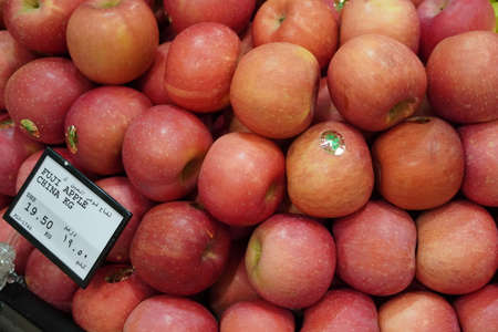 Dubai UAE - November 2019: Bunch of pink apples on boxes in supermarket. Apple put on sale shelves in the supermarket. Fresh ripe apples displayed beautifully.のeditorial素材