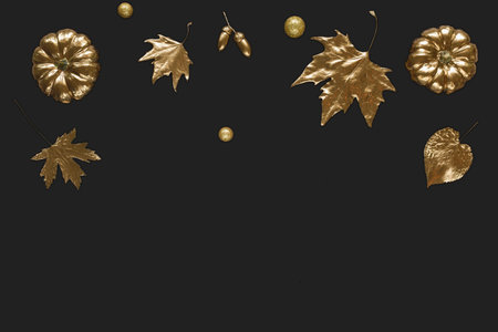 Autumn composition of shiny golden pumpkin, maple leaves and acorns. Halloween decorations. Trendy...