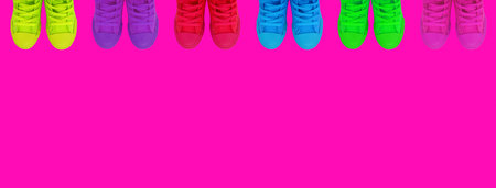 Multicolored sneakers on a bright backgroundMulticolored bright sneakers on a bright pink background.Copy spaceの写真素材