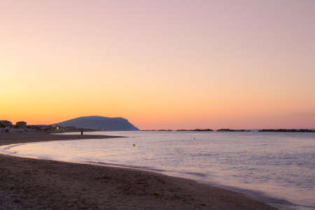 Beautiful sunset on the shores of the Atlantic Ocean overlooking Mount Conero, Marche, Italy, Europe.の写真素材