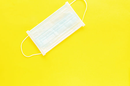Medical mask on yellow background. Protection against virus, coronavirus, flu, colds, diseases....