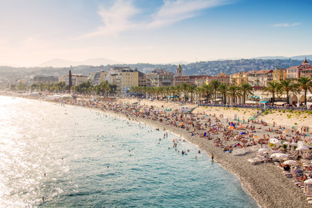 Nice, France, Cote dAzur - August 9, 21: beautiful panoramic promenade from the French Riviera, public beach, famous promenade, palm trees and houses of Nice.のeditorial素材