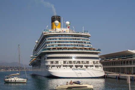 The luxury cruise ship Costa Firenze, Genova docked at Port of Savona against a blue sky. Adventure and travel. Landscape with a cruise liner on the Ligurian Sea. Savona ,Italy,Liguria ,August 15,2021のeditorial素材