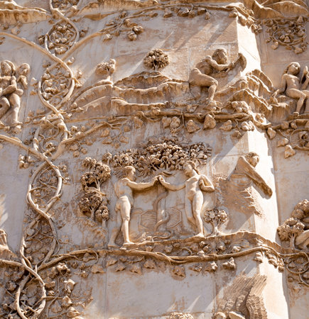 Detail stories of genesis, Adam and Eve in the Garden of Eden, first pillar, external bas-relief of the facade of the famous Cathedral of Santa Maria Assunta in Orvieto, Umbria Italy, Terniの写真素材