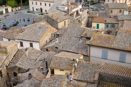 Aerial view of the cityscape and tiled roofs of the old famous city of Bolsena at sunset. Province...