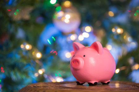Pink piggy bank on the bokeh background of the Christmas holiday. The concept of investment in the future of the child, savings, financial planning, fulfillment of desiressの写真素材