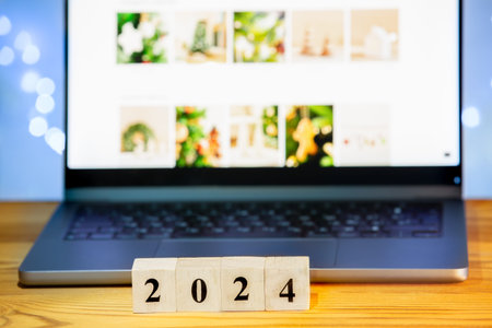 2024 wooden block on laptop background. Goal, task, resolution, strategy, plan, finance, budget,...