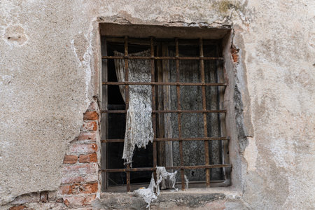 Abandoned house interior, gloomy window with light and shadows in a dark room in the attic, corridor or basement.の写真素材
