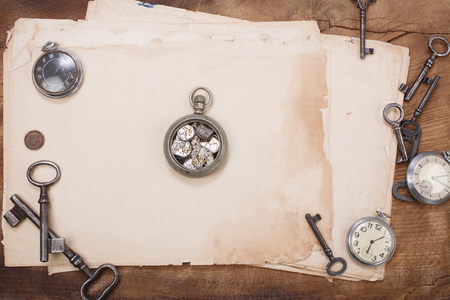 old papers and pen with vintage pocket watch backgroundの写真素材