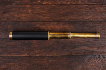 Retro vintage naval spyglass telescope on wooden backgroundの写真素材